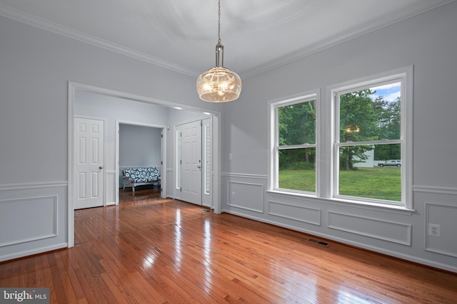 13647 Van Doren Rd, Manassas, VA 20112 - unfurnished dining area featuring a decorative wall, a chandelier, crown molding, hardwood / wood-style flooring, and a wainscoted wall