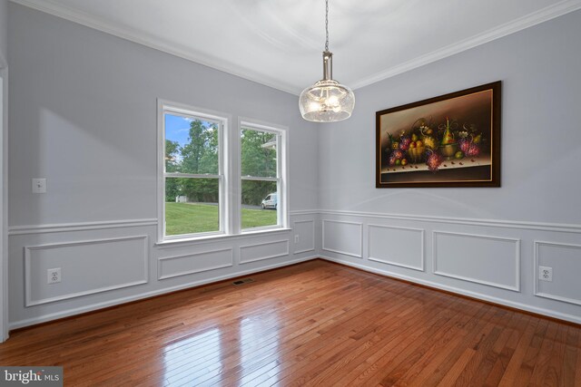 13647 Van Doren Rd, Manassas, VA 20112 - unfurnished room featuring a chandelier, wood-type flooring, crown molding, a decorative wall, and wainscoting