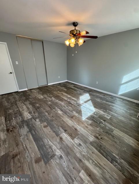unfurnished bedroom with baseboards, ceiling fan, and wood finished floors