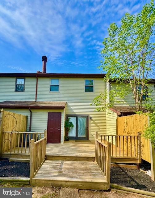 back of property featuring a deck