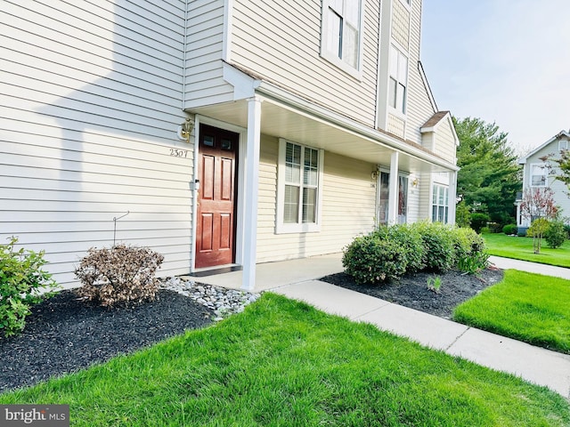 doorway to property with a yard
