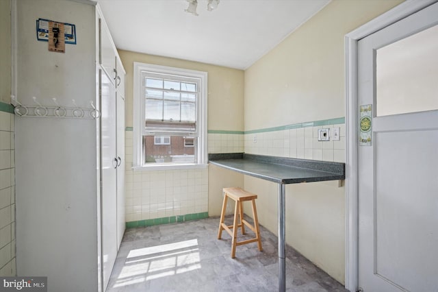 interior space with tile walls