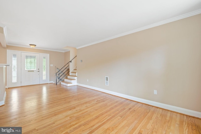 unfurnished living room with crown molding, baseboards, stairs, and light wood-style flooring