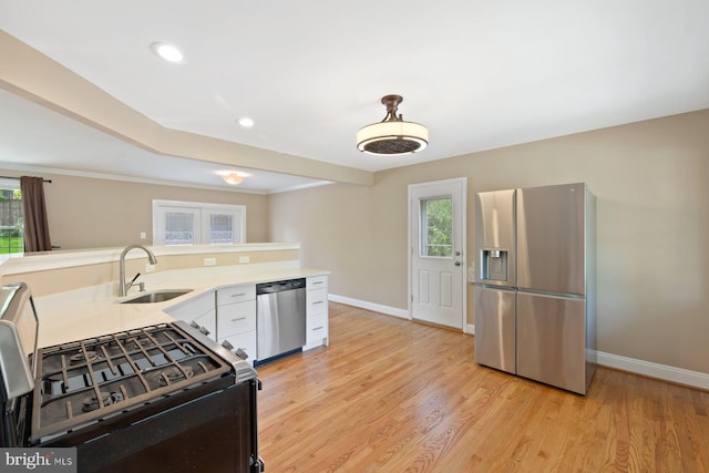 kitchen with light countertops, stainless steel appliances, baseboards, and plenty of natural light