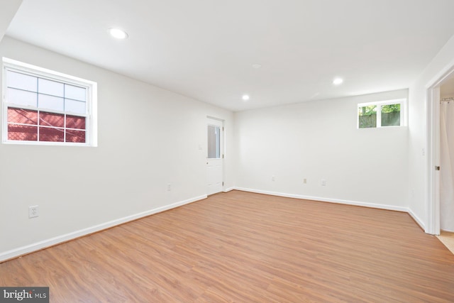 unfurnished room with light wood-style floors, recessed lighting, and baseboards
