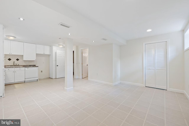 unfurnished living room featuring a sink, baseboards, recessed lighting, and visible vents