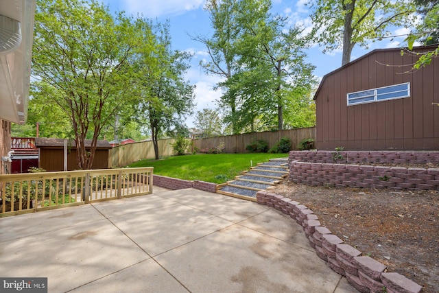 view of patio featuring an outdoor structure, a fenced backyard, and a storage shed