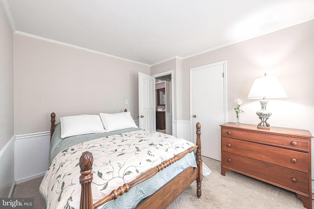 bedroom with crown molding and light carpet