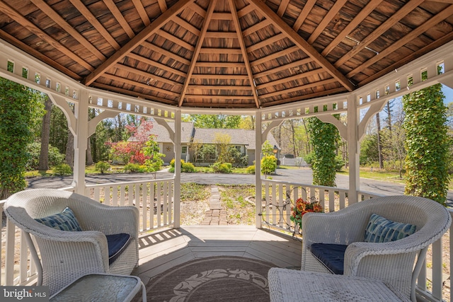 wooden terrace featuring a gazebo and covered porch