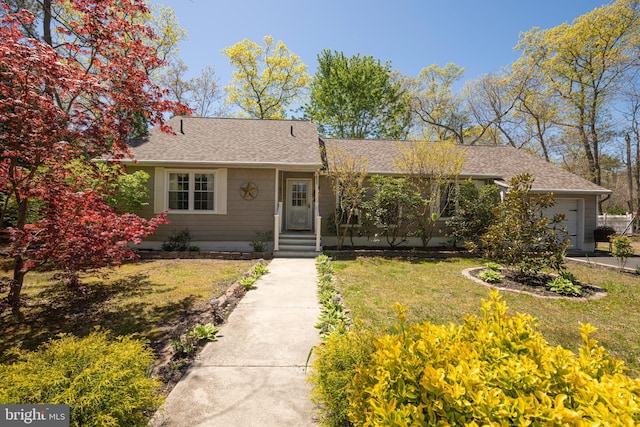 ranch-style house featuring a garage, a shingled roof, and a front yard