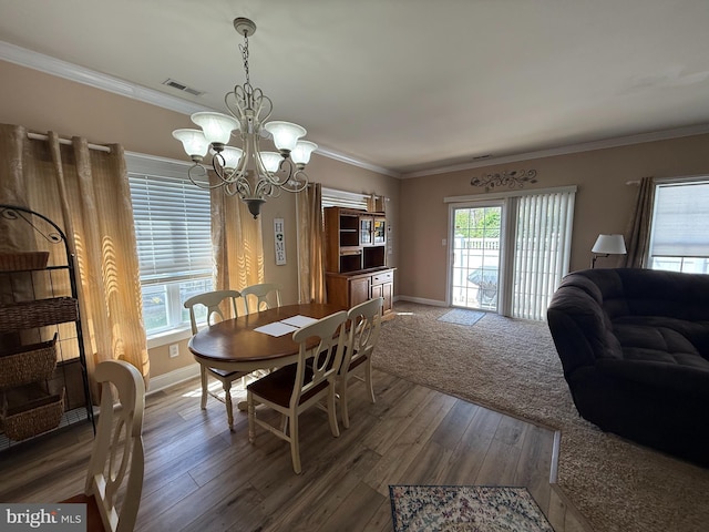 dining space featuring baseboards, dark wood-style flooring, a chandelier, and visible vents