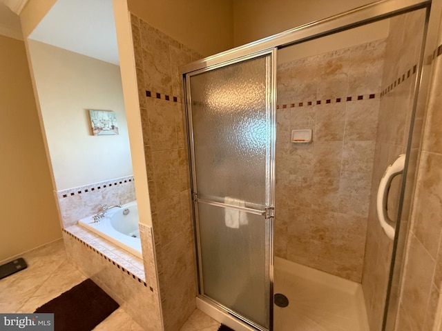 full bathroom featuring tile patterned floors, a shower stall, and a garden tub
