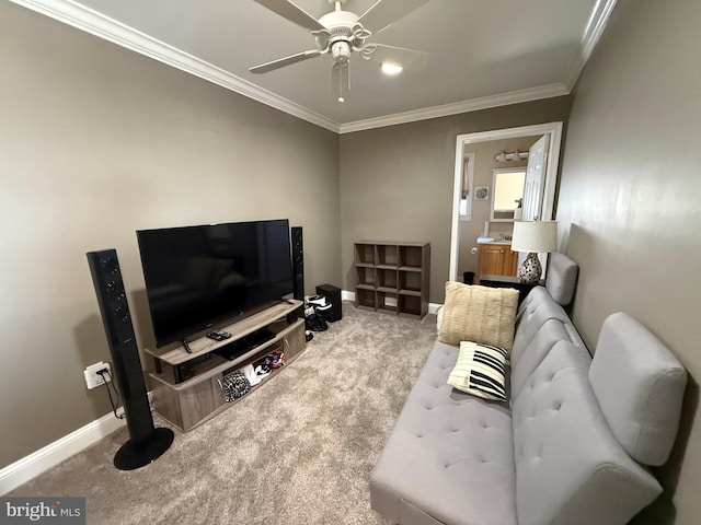 living area with baseboards, carpet flooring, a ceiling fan, and crown molding