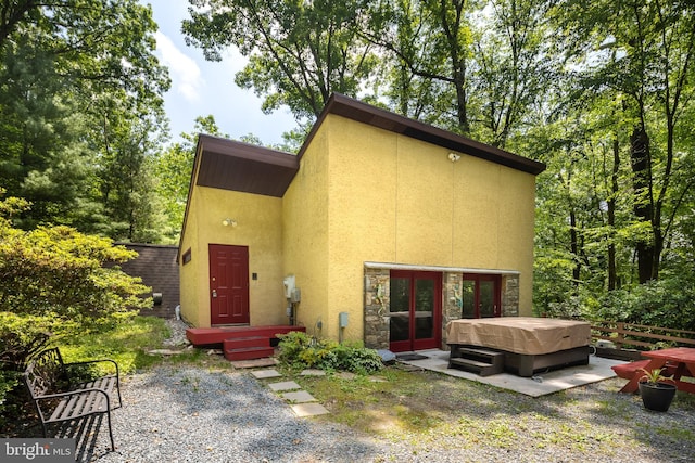 1738 Shanwick Rd, Forest Hill, MD 21050 - back of property featuring a hot tub, stucco siding, a patio, and stone siding