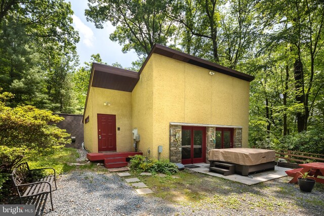 1738 Shanwick Rd, Forest Hill, MD 21050 - back of property featuring a hot tub, stucco siding, a patio, and stone siding