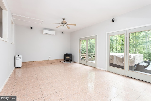 1738 Shanwick Rd, Forest Hill, MD 21050 - spare room featuring a wall unit AC, attic access, a wood stove, ceiling fan, and light tile patterned flooring
