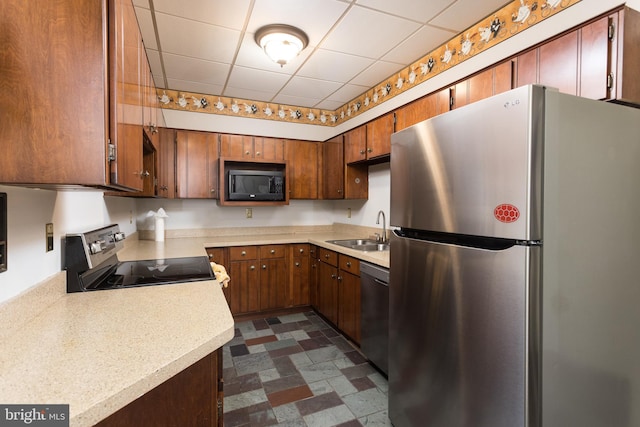 1738 Shanwick Rd, Forest Hill, MD 21050 - kitchen with stainless steel appliances, a sink, light countertops, a paneled ceiling, and brown cabinetry