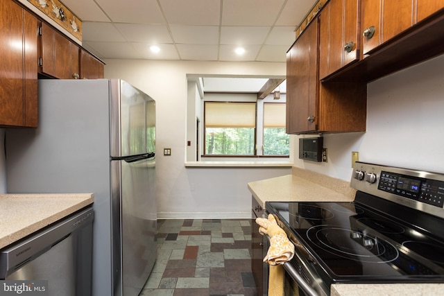 1738 Shanwick Rd, Forest Hill, MD 21050 - kitchen with stainless steel appliances, baseboards, a drop ceiling, light countertops, and brown cabinets