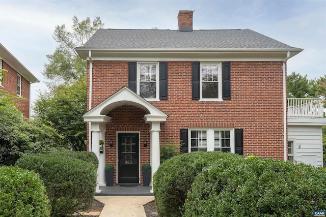 883 Locust Ave, Charlottesville, VA 22902 - colonial-style house with brick siding, roof with shingles, and a chimney