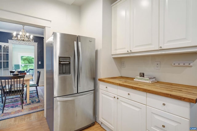 883 Locust Ave, Charlottesville, VA 22902 - kitchen with wooden counters, stainless steel refrigerator with ice dispenser, white cabinets, a chandelier, and light wood-style flooring