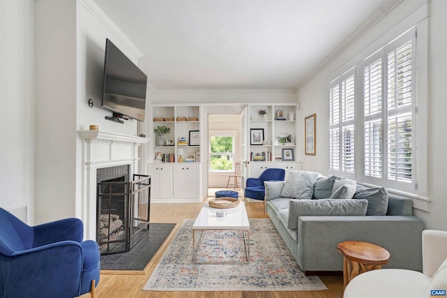 883 Locust Ave, Charlottesville, VA 22902 - living room featuring crown molding, a fireplace, built in features, wood finished floors, and visible vents