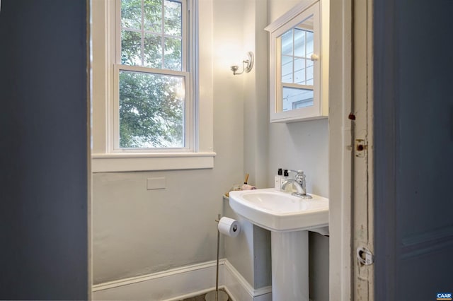 883 Locust Ave, Charlottesville, VA 22902 - half bathroom with baseboards and a wealth of natural light