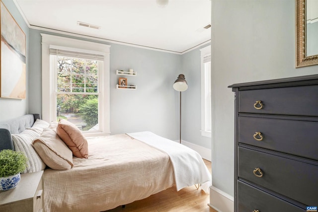 883 Locust Ave, Charlottesville, VA 22902 - bedroom with visible vents, ornamental molding, light wood-style flooring, and baseboards