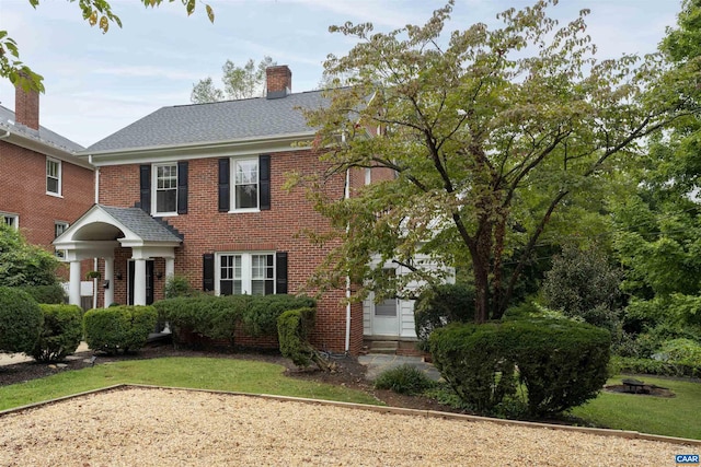 883 Locust Ave, Charlottesville, VA 22902 - view of front of house with brick siding, a chimney, and entry steps