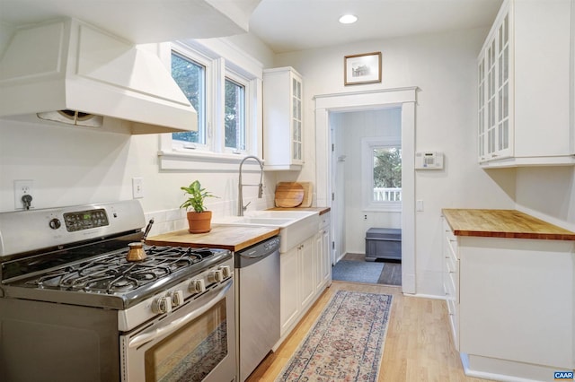 883 Locust Ave, Charlottesville, VA 22902 - kitchen featuring a sink, white cabinets, wood counters, stainless steel appliances, and a wealth of natural light