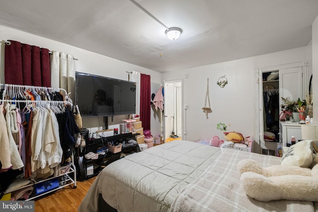 bedroom with wood finished floors