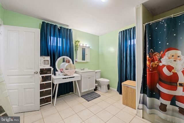 full bathroom with toilet, tile patterned floors, and vanity