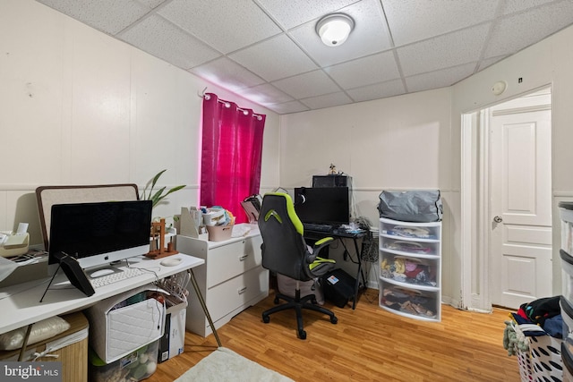 office area with a paneled ceiling and light wood finished floors