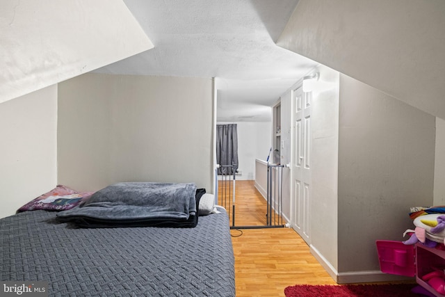 bedroom featuring baseboards and light wood-style floors