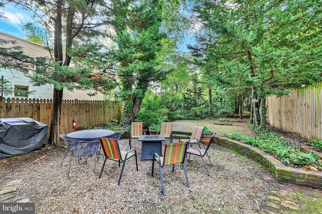 view of yard with a fire pit and fence