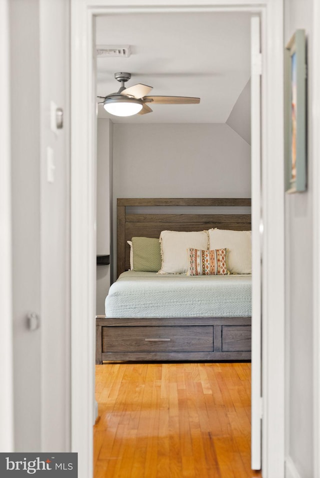 bedroom with a ceiling fan and wood finished floors