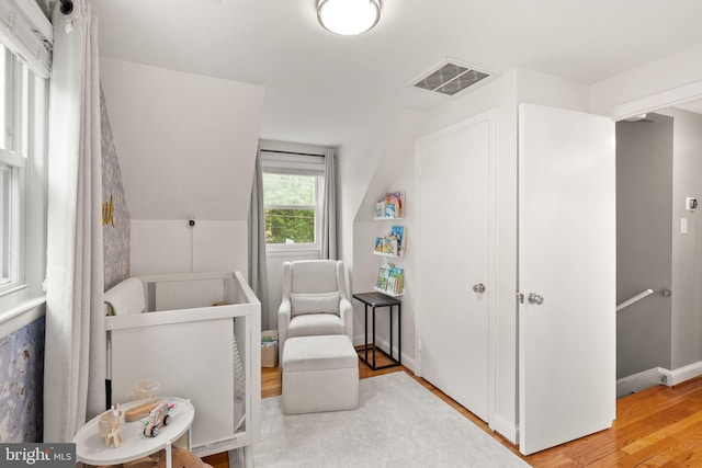 bedroom featuring wood finished floors and vaulted ceiling