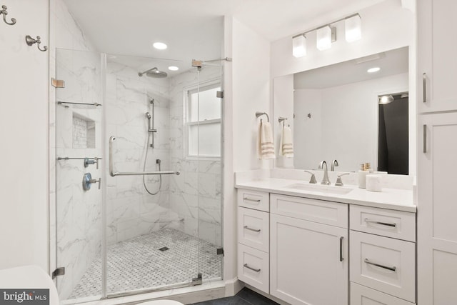 bathroom with a marble finish shower, recessed lighting, vanity, and toilet