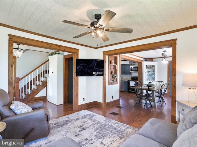 living room featuring ornamental molding, ceiling fan, wood finished floors, and stairway
