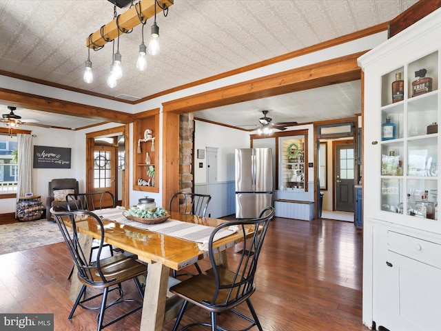 dining room with a ceiling fan, visible vents, crown molding, dark wood finished floors, and an ornate ceiling