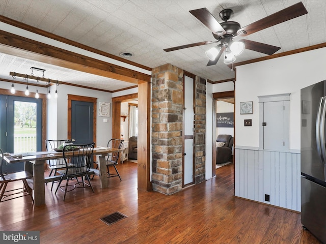 kitchen with freestanding refrigerator, crown molding, visible vents, and wood finished floors