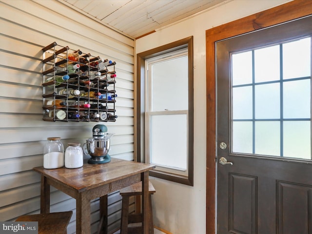 doorway to outside with wood ceiling