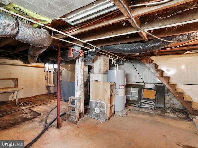 unfinished basement featuring stairs and water heater