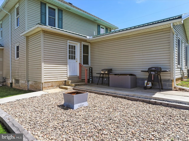 rear view of house featuring a patio and entry steps