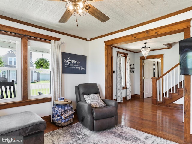 sitting room with baseboards, a ceiling fan, wood finished floors, and stairway