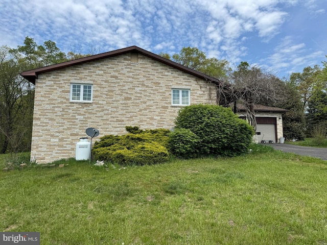 15004 Burnt Mill Rd, Shippensburg, PA 17257 - view of home's exterior with a yard, asphalt driveway, a garage, and brick siding