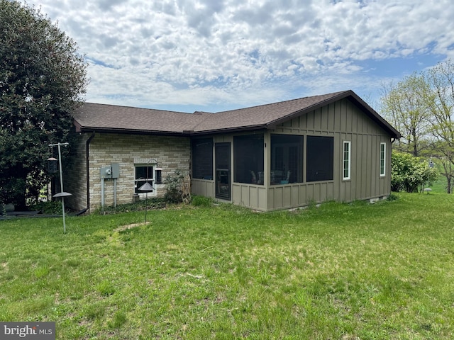 15004 Burnt Mill Rd, Shippensburg, PA 17257 - rear view of house featuring board and batten siding, a sunroom, a yard, and roof with shingles