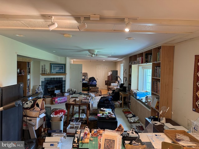 15004 Burnt Mill Rd, Shippensburg, PA 17257 - living area featuring track lighting, a ceiling fan, and a tiled fireplace