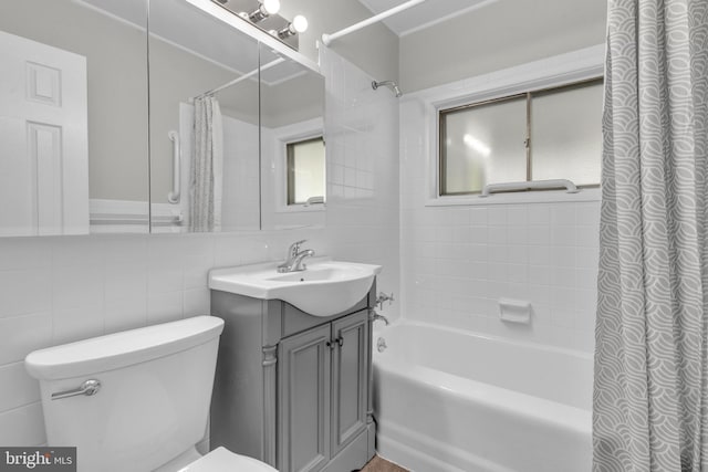 bathroom with shower / bath combination with curtain, tile walls, toilet, and vanity