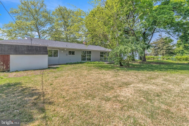 back of property with a yard