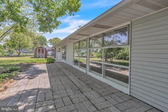 view of patio with a storage unit and an outbuilding